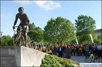 People standing near bicycle statue