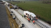 Workers installing concrete slab railway