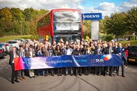 Group of people in front of double-decker bus