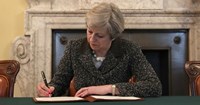 Theresa May signing document