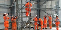 Workers in fluro working on electric wire