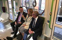 People in suits sitting on train