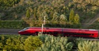 Fast red train in forest