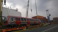 Train car being unloaded from freight ship