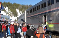 Skiiers getting on to train in the snow