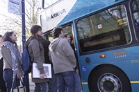 People boarding bus bus