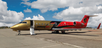 Red and gold plane on tarmac