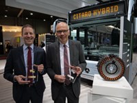 Representatives from Daimler Buses holding awards