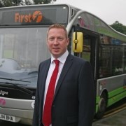Man in suit in front of bus