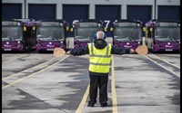 Airport traffic controller in front of bus