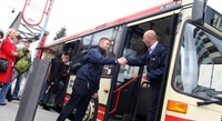 Bus driver and passenger shaking hands