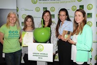 Five women in green posing with award