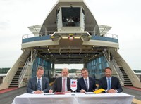 Representatives signing agreement on ferry