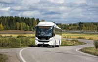 White bus driving on road