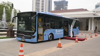 Blue bus near traffic cones