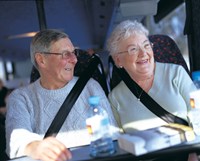 Older couple sitting in bus