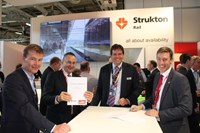 Men posing for photo in front of Strukton Rail line