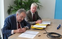 Two men signing contract