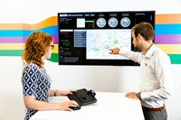 Woman and man using a smartboard
