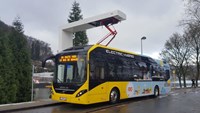 Yellow electric hybrid bus charing