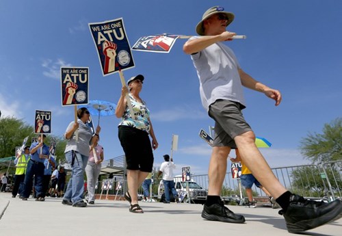 Members of the Amalgamated Transit Union Local 1433 strike in front of the First Transit Inc., bus depot on in Tempe, Arizona in 2013. (Ross D. Franklin/AP)