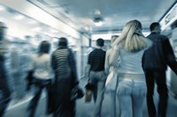 People walking through subway tunnel