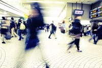 People walking through a busy metro