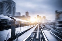 Fast, sliver train with city background