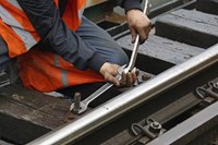 Rail worker fixing train tracks