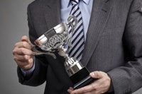 Man holding sliver trophy